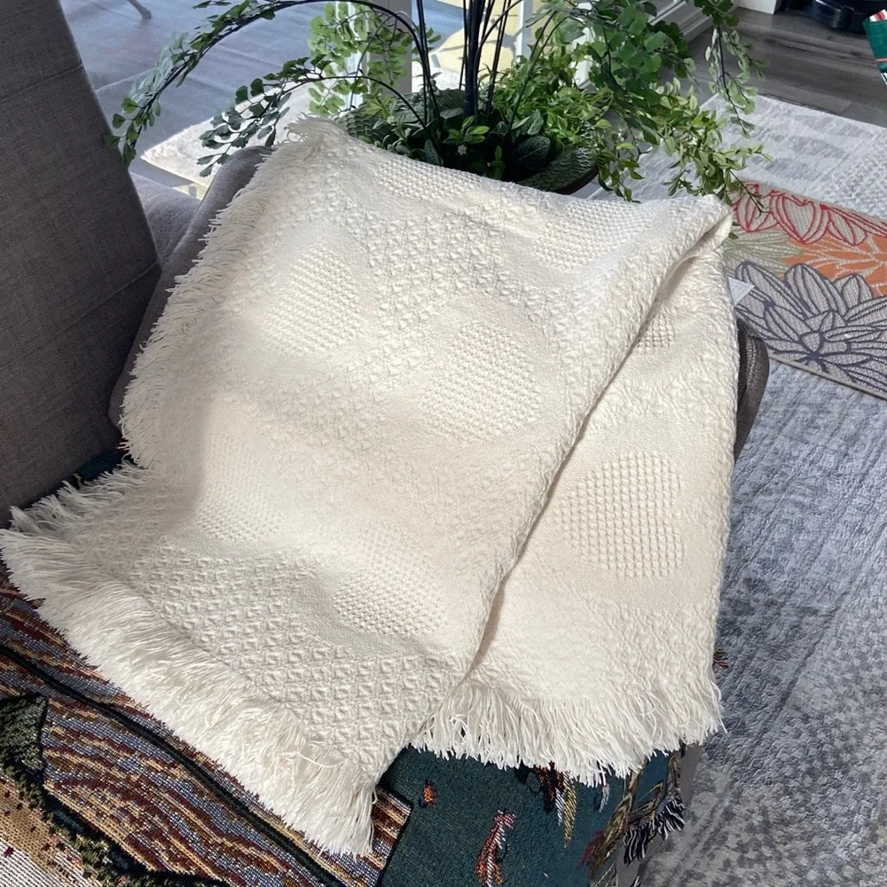Beautiful white blanket with subtle heart detail.